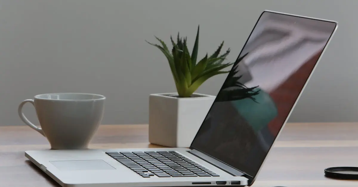 Silver Laptop and White Cup on Table